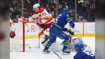 Calgary Flames' Tyler Toffoli (73) scores against Vancouver Canucks goalie Thatcher Demko during the second period of an NHL hockey game in Vancouver, on Friday, March 31, 2023. THE CANADIAN PRESS/Darryl Dyck
