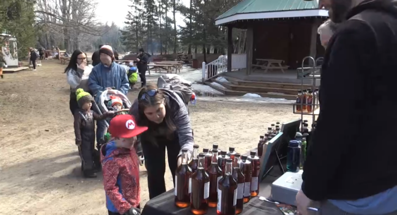A family picks out their bottle of maple syrup at Drysdale's Tree Farm on Sat., April 1 (Steve Mansbridge/CTV News). 