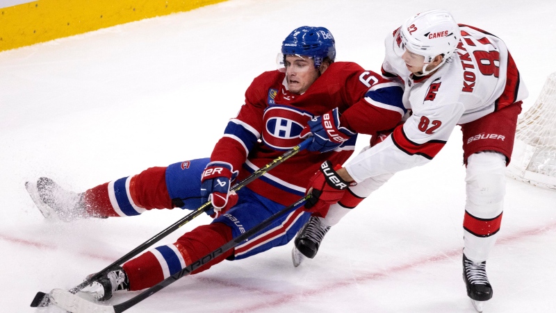 Carolina Hurricanes centre Jesperi Kotkaniemi checks Montreal Canadiens left wing Mike Hoffman during second period NHL hockey action in Montreal, Saturday April 1 2023. THE CANADIAN PRESS/Allen McInnis