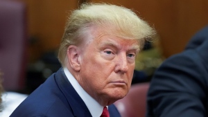 Former U.S. president Donald Trump sits at the defence table with his defence team in a Manhattan court, Tuesday, April 4, 2023, in New York. (AP Photo/Seth Wenig) 