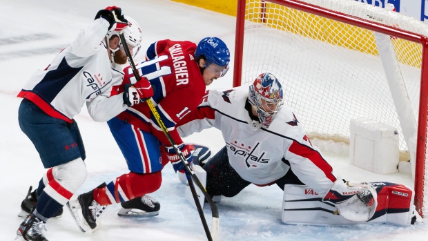 Montreal Canadiens' Brendan Gallagher (11) squeezes between Washington Capitals goalie Darcy Kuemper and Capitals' Matt Irwin (52) during second period NHL hockey action in Montreal, Thursday, April 6, 2023. THE CANADIAN PRESS/Peter McCabe