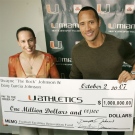 Actor Dwayne "The Rock" Johnson, right, and wife Dany Garcia Johnson pose with their $1 million gift to the University of Miami's football facilities renovation fund, and will have the Hurricanes' locker room named in his honor, in Coral Gables, Fla., Tuesday, Oct. 2, 2007. (AP Photo / Alan Diaz)