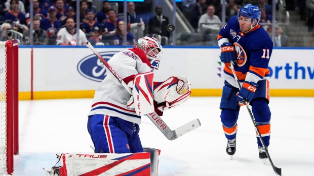 Montreal Canadiens goaltender Sam Montembeault (35) stops a shot on goal by New York Islanders' Zach Parise (11) during the second period of an NHL hockey game Wednesday, April 12, 2023, in Elmont, N.Y. (AP Photo/Frank Franklin II)