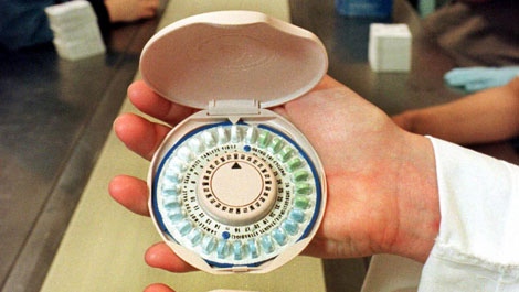 A new birth control pill container designed to look like a woman's makeup compact for Ortho-McNeil Pharmaceutical Inc., of Raritan, N.J., is displayed at the manufacturer's assembly line May 28, 1999. (AP Photo/Mike Derer)