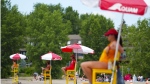 Lifeguards work at Britannia Beach of the Ottawa River in Ottawa, Friday, June 24, 2022. Ontario is proposing to lower the minimum age for lifeguards to 15, in part to address staff shortages many municipalities experienced last summer. THE CANADIAN PRESS/Sean Kilpatrick
