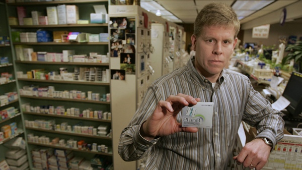 Pharmacist Matt Hartwig holds up a dose of Plan B, which is commonly referred to as the morning-after pill, at his pharmacy in Excelsior Springs, Mo. in this Jan. 12, 2006 photo. (AP/Charlie Riedel)