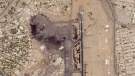 This satellite photo from Planet Labs PBC shows damaged aircraft, including one on fire, at Khartoum International Airport in Khartoum, Sudan, Monday, April 17, 2023. (Planet Labs PBC via AP)