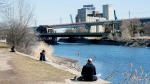 People relax by the Lachine Canal on a mild spring day in Montreal, Sunday, April 9, 2023. THE CANADIAN PRESS/Graham Hughes