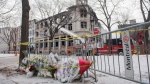 A makeshift memorial is shown at the scene following a fire in Old Montreal, Sunday, March 19, 2023, that gutted a heritage building. THE CANADIAN PRESS/Graham Hughes