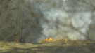 Flames can be seen from a brush fire in this undated file photo.