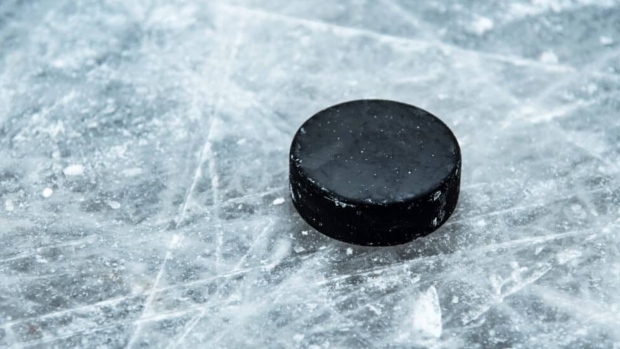 A stock photo shows a hockey puck on ice. 