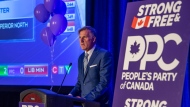 People's Party of Canada Leader Maxime Bernier speaks from a podium to supporters during the PPC headquarters election night event in Saskatoon, Sask., Monday, Sept. 20, 2021. THE CANADIAN PRESS/Liam Richards