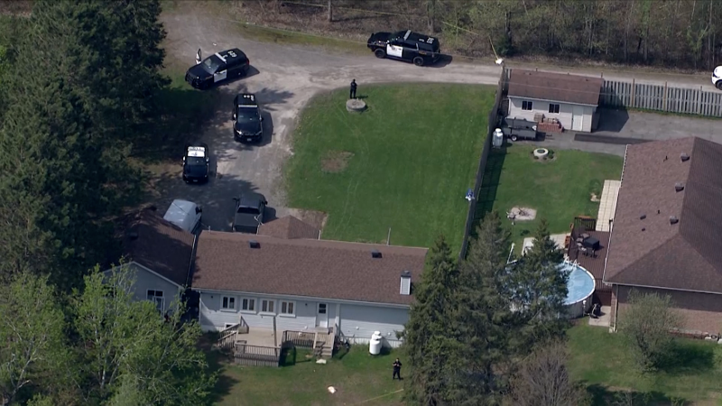 Ontario Provincial Police cruisers parked at a home in Bourget, Ont. as the investigation continues into a shooting that killed an OPP officer on Thursday. (CP24)