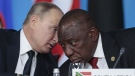 Russian President Vladimir Putin, left, speaks to South African President, Cyril Ramaphosa, right, during a plenary session at the Russia-Africa summit in the Black Sea resort of Sochi, Russia on Oct. 24, 2019. The U.S. ambassador to South Africa, Reuben Brigety, has accused South Africa of providing weapons to Russia saying the U.S. government was certain that weapons were loaded onto a cargo ship that docked secretly at a naval base near the city of Cape Town for three days in December. (Sergei Chirikov/Pool Photo via AP, File)