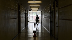 A teacher in a hallway at a school in Scarborough, Ont., on Monday, September 14, 2020. Toronto District School Board says more than 300 students have been involved in violent incidents in the city so far this school year. THE CANADIAN PRESS/Nathan Denette
