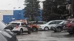 A photo shared with CTV News shows police and a tow truck recovering the van from a parking lot outside an apartment building at 615 Confederation Drive. (Courtesy: Anonymous)
