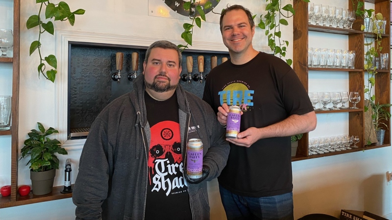 Tire Shack Brewing Co brew master Henry Soares (left) and co-owner Alan Norman hold their new beer Garden Party on Thursday. The beer was designed using Artificial Intelligence. (Derek Haggett/ CTV News) 