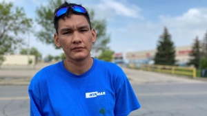 Ezekial Bigknife stands outside the Canadian Tire location where he says he was racially profiled and assaulted. (Allison Bamford / CTV News) 
