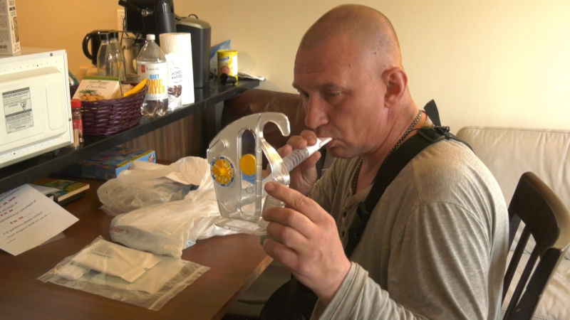  Ivan Pylypchuck tests his lung function at home after being released from the hospital more than a month after he was randomly stabbed at an Edmonton bus stop. (Dave Mitchell/CTV News Edmonton)