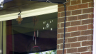 A bullet hole in the window of the apartment building in Pembroke, Ont. that was the scene of a double homicide on Monday. Photo taken on Friday, May 26, 2023. (Dylan Dyson/CTV News Ottawa)