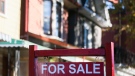 A for sale sign is displayed in front of a house in the Riverdale area of Toronto on Wednesday, September 29, 2021. THE CANADIAN PRESS/Evan Buhler