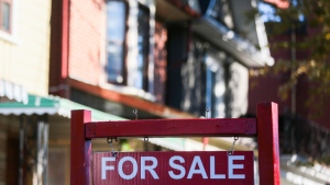 A for sale sign is displayed in front of a house in the Riverdale area of Toronto on Wednesday, September 29, 2021. THE CANADIAN PRESS/Evan Buhler