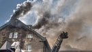 Firefighters respond to a five-alarm fire at the former Monastere du Bon Pasteur, a 19th century heritage building on Friday May 26, 2023 in Montreal. THE CANADIAN PRESS/Christinne Muschi