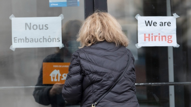 A customer enters a restaurant with help wanted signs, Nov. 17, 2021, in Laval, Que. THE CANADIAN PRESS/Ryan Remiorz