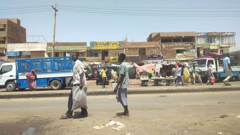 People walk by a market in Khartoum, Sudan, May 23, 2023. (AP Photo)