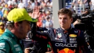 Red Bull driver Max Verstappen of the Netherlands, right, waves at the end of the Formula One qualifying session at the Monaco racetrack, in Monaco, May 27, 2023. (AP Photo/Luca Bruno)
