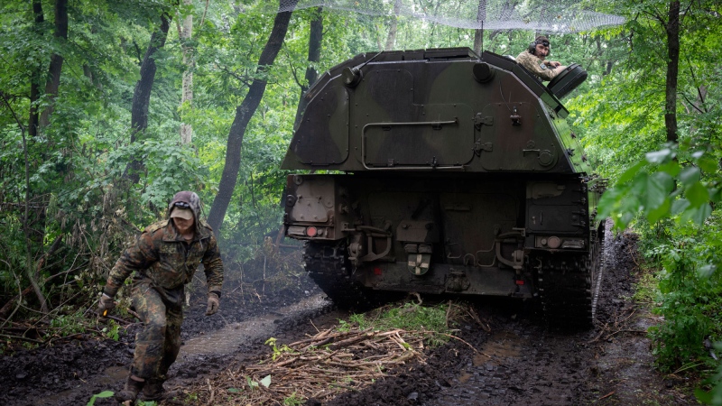 A Ukrainian army, German self-propelled Panzerhaubitze 2000, artillery drives to its position at the frontline near Bakhmut, Donetsk region, Ukraine, Saturday, May 27, 2023. (AP Photo/Efrem Lukatsky)