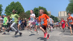 Young runners race down Laurier Avenue at the start of the Kids' Marathon during Tamarack Ottawa Race Weekend. (Jackie Perez/CTV News Ottawa)