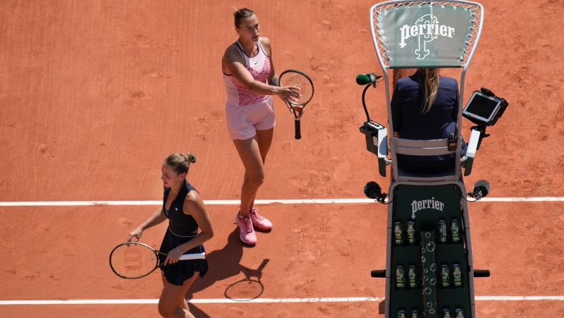 Aryna Sabalenka of Belarus, top, and Ukraine's , left, refused to shake hands at the end of their first round match of the French Open tennis tournament at the Roland Garros stadium in Paris, Sunday, May 28, 2023. Sabalenka won in two sets, 6-3, 6-2. (AP Photo/Christophe Ena)