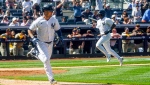 New York Yankees Isiah Kiner-Falefa, left, runs to first base on a single that scores teammate Greg Allen, right, for a tenth inning win in a baseball game against the San Diego Padres, Saturday, May 27, 2023, in New York. (AP Photo/Bebeto Matthews)