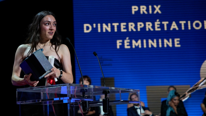 Merve Dizdar accepts the award for best actress for 'About Dry Grasses,' during the awards ceremony of the 76th international film festival, Cannes, southern France, Saturday, May 27, 2023 (AP Photo/Daniel Cole)