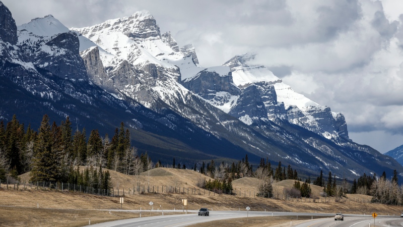 Traffic travels along the Trans Canada Highway past Mount Rundle of the Rocky Mountains near Canmore, Alta., Monday, April 24, 2023.THE CANADIAN PRESS/Jeff McIntosh
