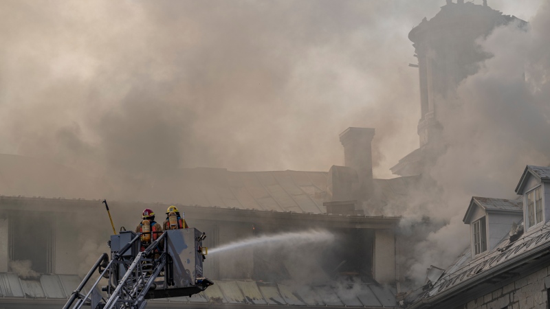 Firefighters respond to a five-alarm fire at the former Monastere du Bon Pasteur, a 19th century heritage building on Friday May 26, 2023 in Montreal. THE CANADIAN PRESS/Christinne Muschi