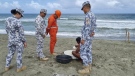 In this handout photo provided by the Philippine Coast Guard, Philippine Coast Guard personnel check on a fisherman while conducting patrol along shore lines in Ilocos Norte province, northern Philippines, as they prepare for the possible effects of Typhoon Mawar on Monday, May 29, 2023. (Philippine Coast Guard via AP)