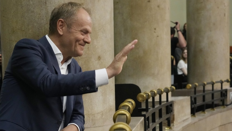 Poland's opposition leader and former prime minister, Donald Tusk, watches lawmakers vote to approve a contentious draft law in parliament in Warsaw, Poland, on Friday, May 26, 2023. (AP Photo/Czarek Sokolowski)