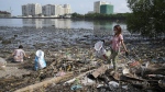 Volunteers pick up garbage along a polluted coastal area in Metro Manila, Philippines Friday, Sept. 16, 2022. (AP Photo/Aaron Favila, File)