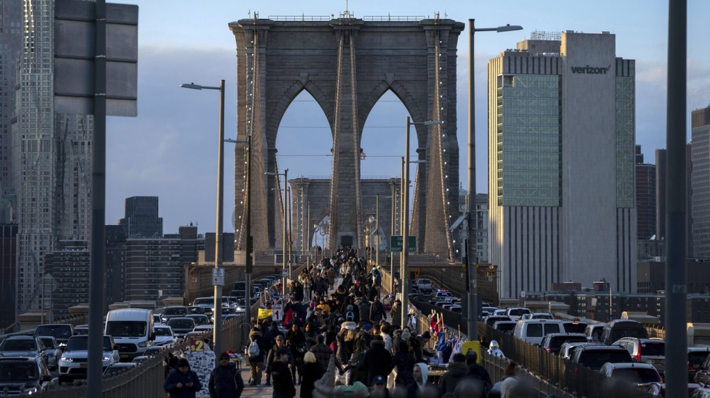People walk on the Brooklyn Bridge