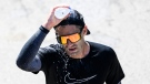 Jonathan Bond of Quebec City pours water on his head after finishing the marathon of the Ottawa Race Weekend in Ottawa, on Sunday, May 28, 2023. (Justin Tang/THE CANADIAN PRESS)