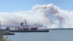 Smoke from wildfire is seen in the distance at the waterfront in Shelburne, N.S. (Jonathan MacInnis/CTV) 