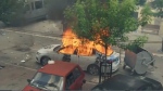 In this grab taken from video, a view of a car set on fire as KFOR soldiers clash with Kosovo Serbs in the town of Zvecan, northern Kosovo, May 29, 2023. (AP Photo)