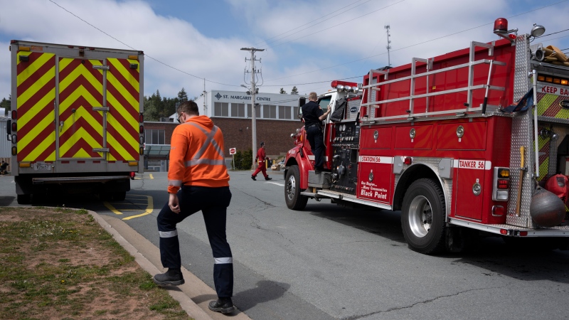 Firefighters and other emergency responders work at a staged command centre within the evacuated zone of the wildfire burning in Tantallon, N.S., outside of Halifax on Monday, May 29, 2023. (THE CANADIAN PRESS/Darren Calabrese)