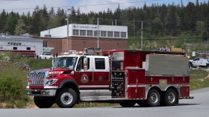 Firefighters with Halifax Regional Fire and Emergency leave a staged command centre within the evacuated zone of the wildfire burning in Tantallon, N.S., outside of Halifax on Monday, May 29, 2023. (THE CANADIAN PRESS/Darren Calabrese)