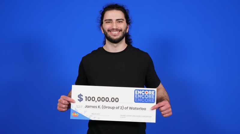 James Knowles poses with his $100,000 win that he won with his mother. (OLG)