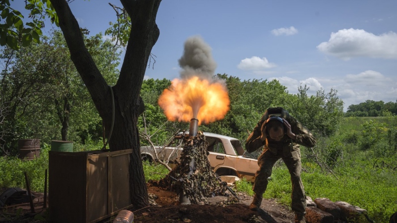 A Ukrainian soldier fires a mortar at Russian positions on the frontline near Bakhmut, Donetsk region, Ukraine, Monday, May 29, 2023. (AP Photo/Efrem Lukatsky)