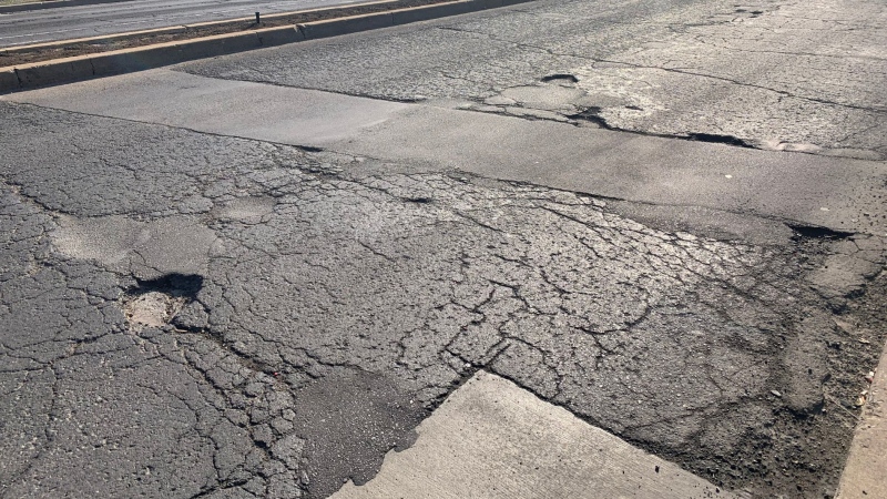 A span of cracked pavement with a pothole is seen in this image dated May 25, 2023. (Submitted: CAA South Central Ontario)