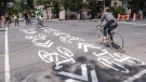 Symbols painted on the street indicate a bicycle path in Montreal on Tuesday, June 21, 2016. Montreal has been known for decades as a global innovator in urban biking and the first city in North America to develop an extensive network of physically separated on-street bicycle lanes. (Paul Chiasson/The Canadian Press via AP)